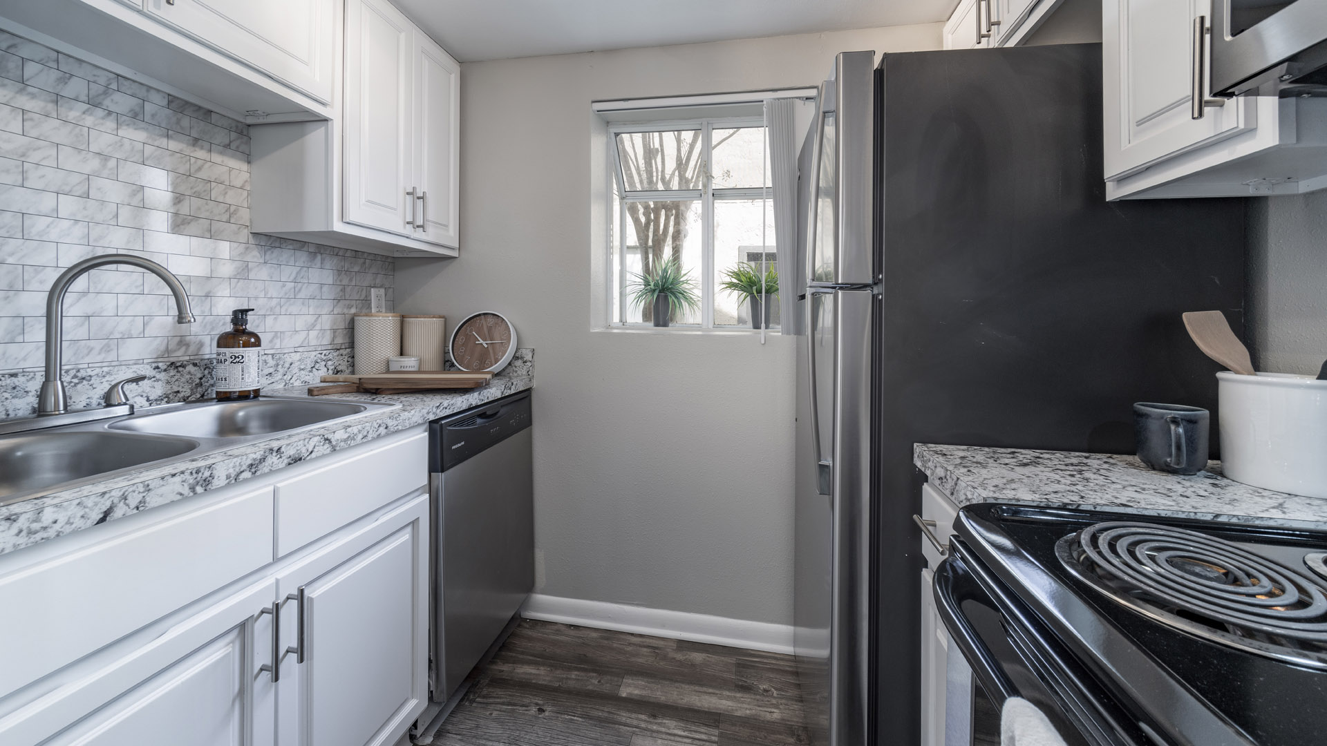 Renovated luxury kitchen with granite-style countertops and stainless steel appliances